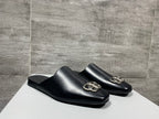 Pair of black leather slide sandals with silver-tone double-ring buckle
