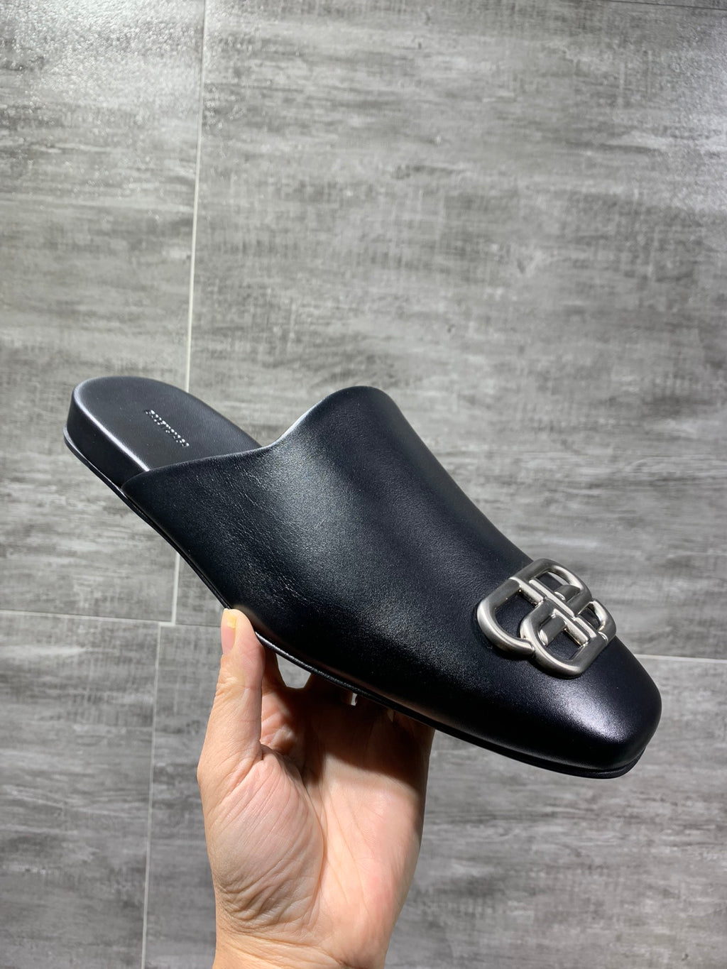 Black leather slide sandal with silver-tone double-ring buckle detail