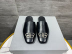 Black leather slide sandals with silver-tone buckle at front; set of 2