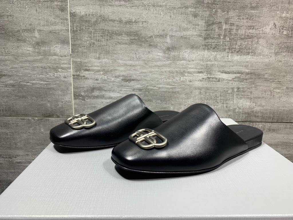 Two black leather slide sandals with silver-tone double-ring buckle hardware