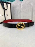 Black leather belt with gold-toned GG buckle and red interior