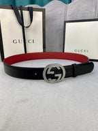 Gucci leather belt with black strap and silver GG buckle, red underside detail
