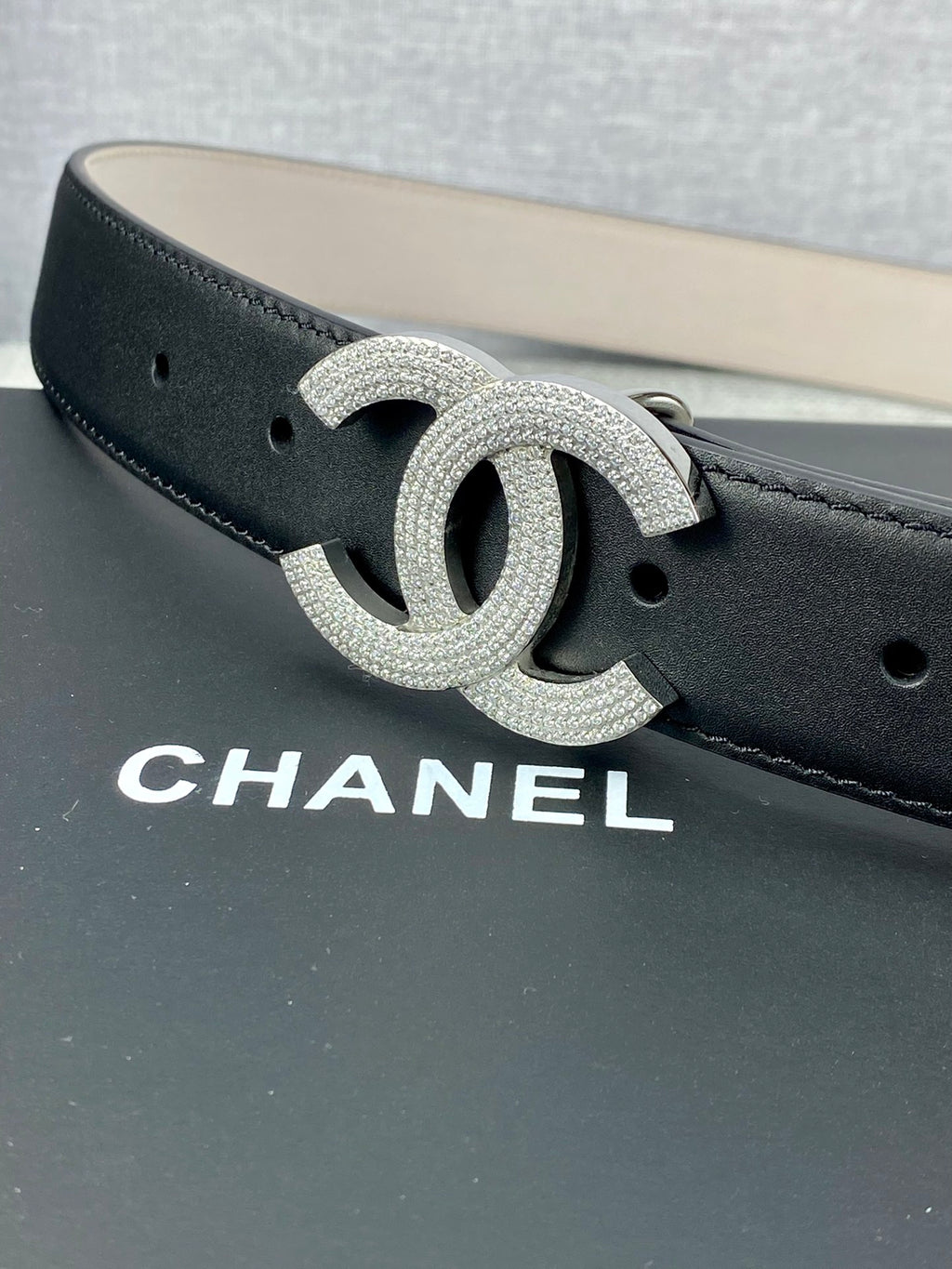 Black leather belt with silver-tone CC logo buckle, detailed glitter finish
