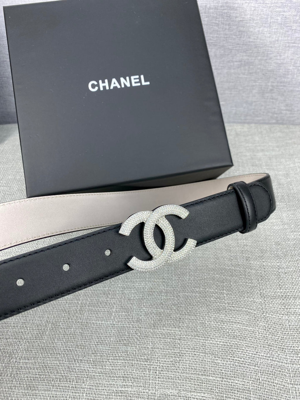 Black leather belt with silver-tone CC buckle and smooth adjustable end