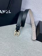 Black leather belt with silver-tone CC buckle and punched sizing holes