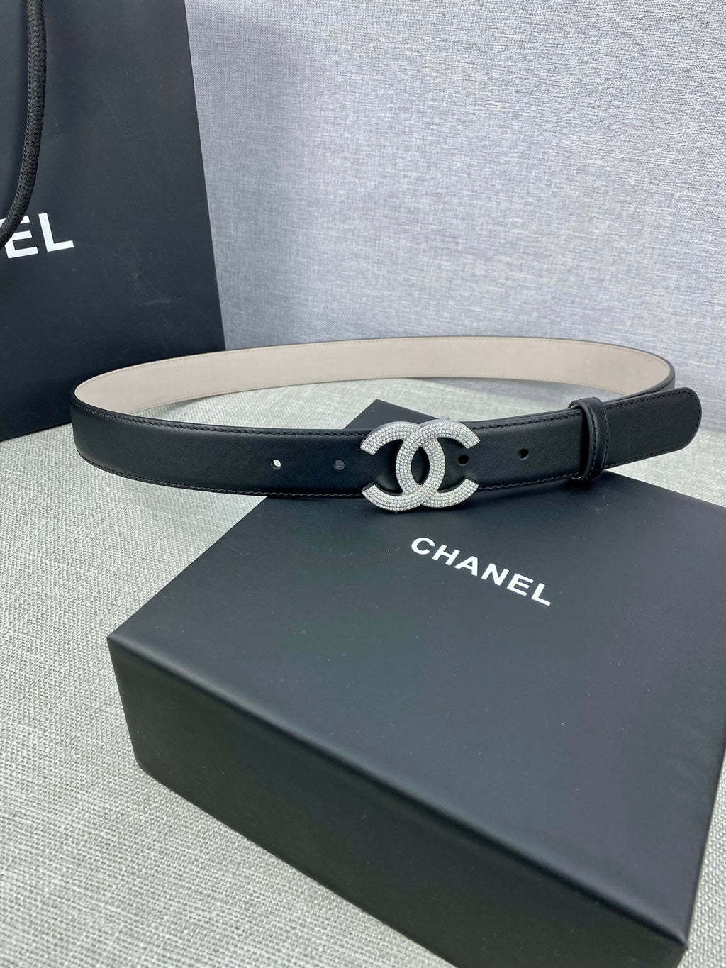 Black leather belt with silver-tone CC buckle and single-row punched holes
