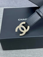 Black leather belt with silver-tone CC buckle on a slim strap