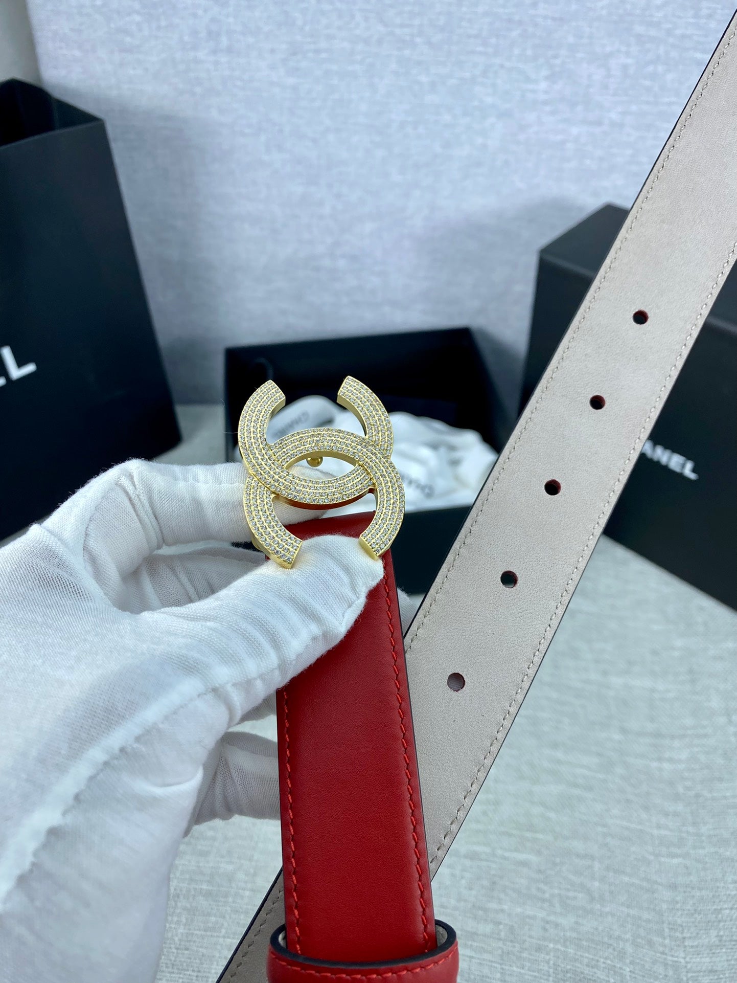Red leather belt with gold-tone Double C buckle and light-beige reverse strap
