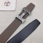 Brown and dark leather belts with silver-tone engraved buckles