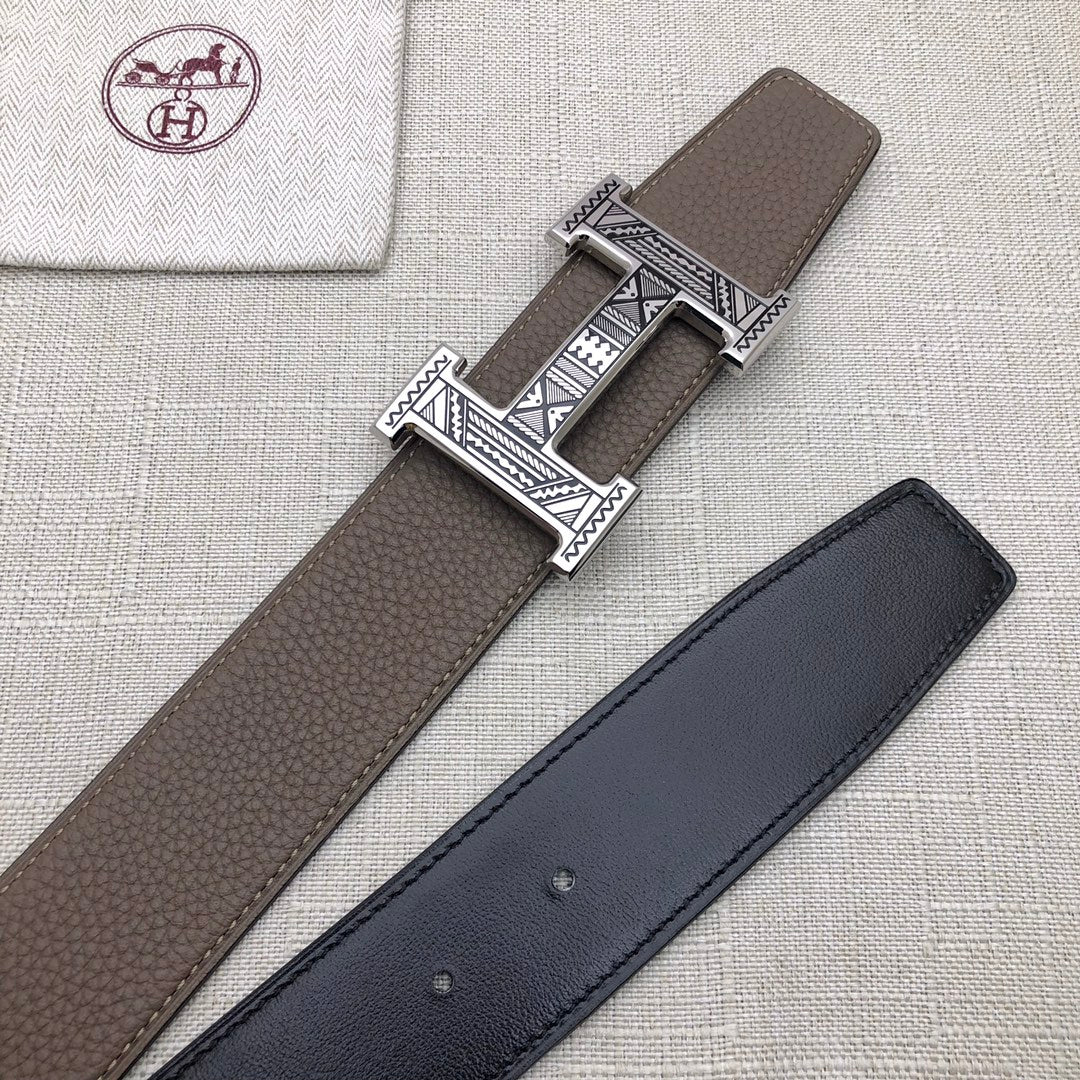 Brown and dark leather belts with silver-tone engraved buckles