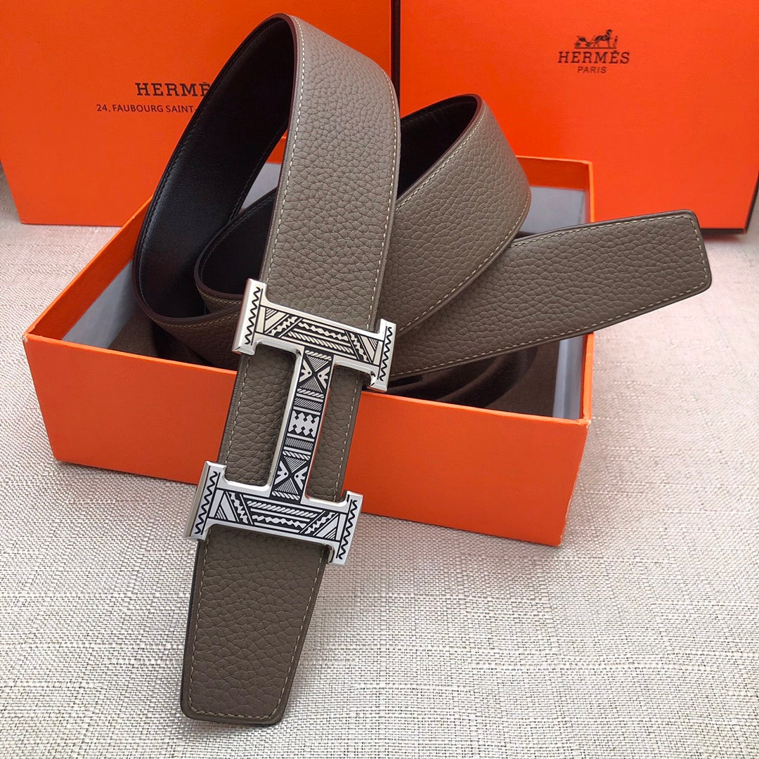 Taupe leather belt with silver-tone engraved buckle and textured strap