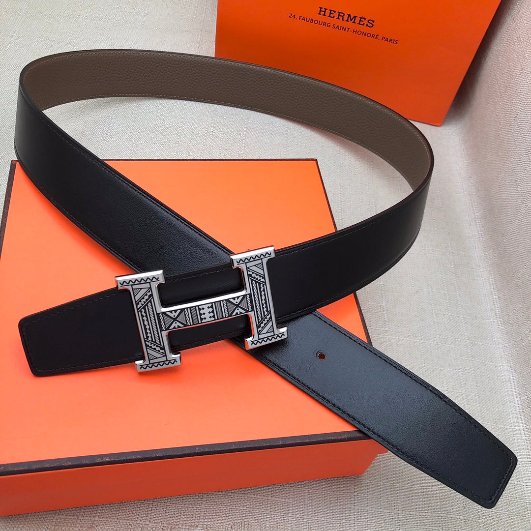 Black leather belt with silver-tone engraved buckle and keeper tab