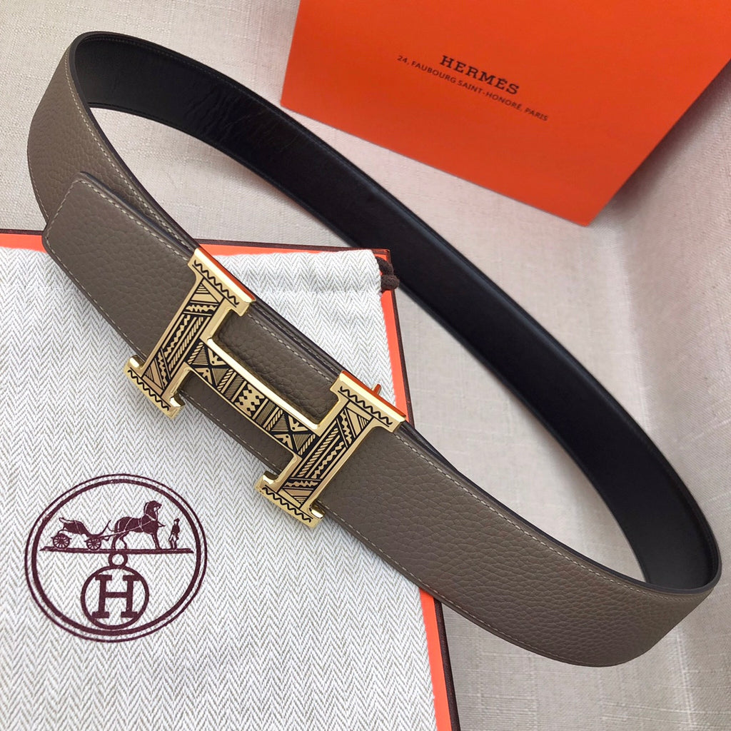 Taupe leather belt with silver-tone engraved buckle and keeper detail