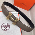 Taupe leather belt with silver-tone engraved buckle and keeper detail
