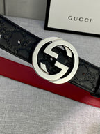 Gucci belt close-up: black embossed leather with silver-tone GG buckle