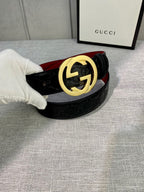 Gucci belt with black embossed leather and gold-tone GG buckle, red underside