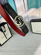 Gucci belt with black embossed leather and large silver-tone GG buckle, red underside