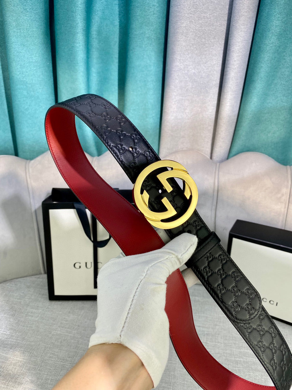 Gucci black leather belt with textured pattern and gold-tone double-G buckle