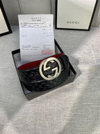 Gucci black leather belt with embossed pattern and silver double-G buckle
