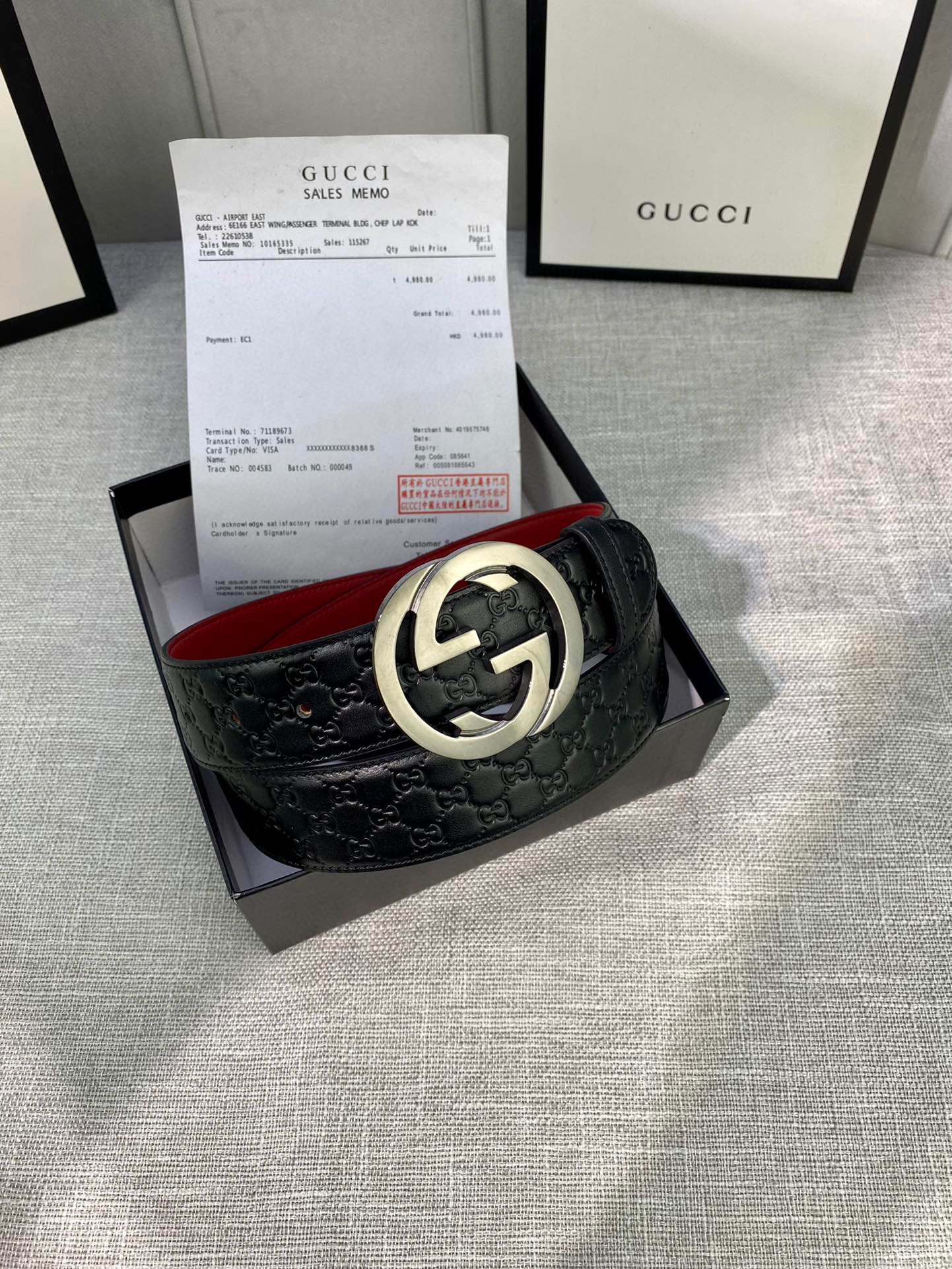 Gucci black leather belt with embossed pattern and silver double-G buckle