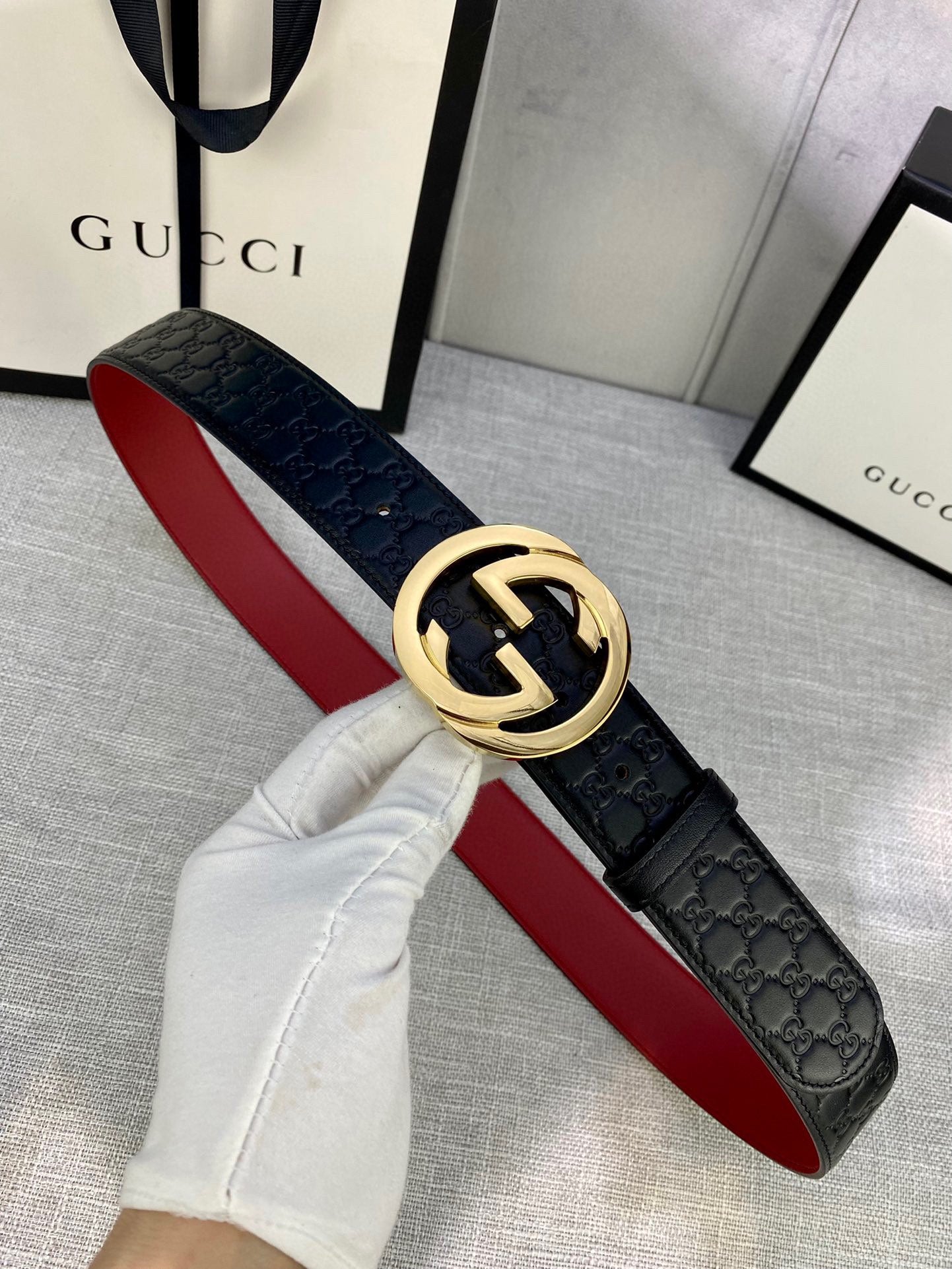 Gucci black leather belt with embossed pattern and gold-tone double-G buckle