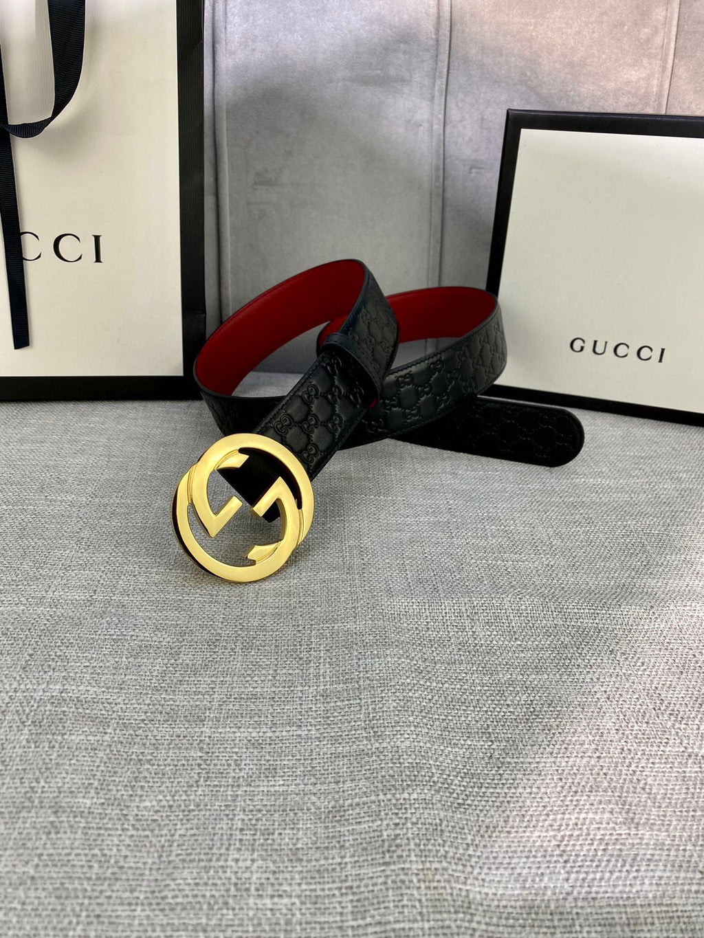 Gucci black leather belt with embossed pattern and gold-tone double-G buckle