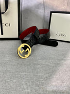 Gucci black leather belt with embossed pattern and gold-tone double-G buckle