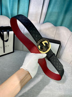 Gucci belt with black GG-pattern leather, round gold buckle, and red underside