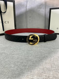 Gucci belt in black textured leather with gold-tone double-G buckle and red underside