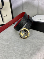 Gucci belt on display: black embossed strap with gold double-G buckle and red lining