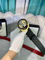 Gucci belt, black embossed leather with large gold buckle and red inner strap