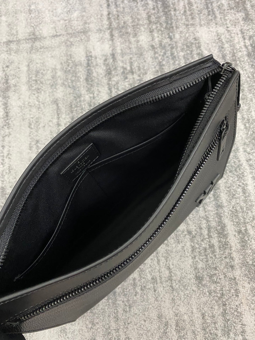 Louis Vuitton leather bag open view, black interior lining with zipper track