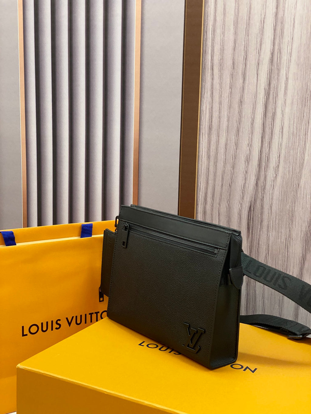 Louis Vuitton leather crossbody bag, black with adjustable strap and front zipper