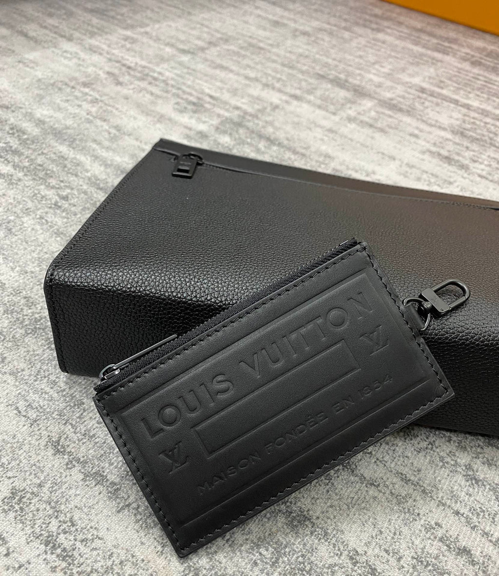 Louis Vuitton leather card case, black textured finish with embossed logo panel