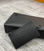 Louis Vuitton leather card case, black textured finish with embossed logo panel