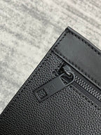 Louis Vuitton zip pocket detail, black textured leather with metal pull and trim