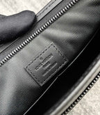 Louis Vuitton leather interior tag, black with embossed logo and zipper seam