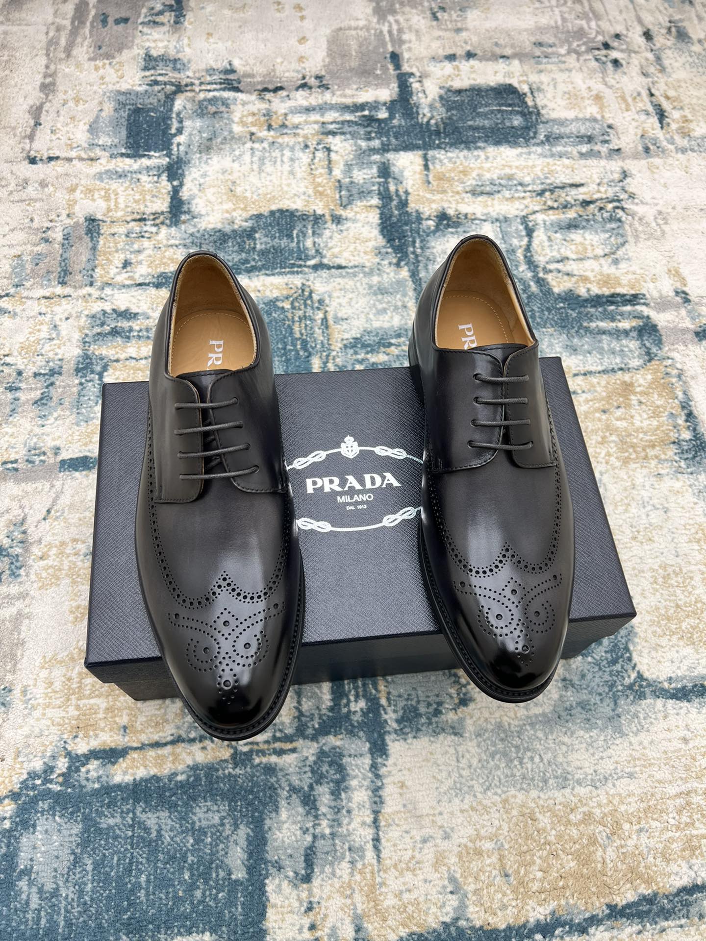 Prada unisex lace-up oxford shoes, dark leather with brogue perforations