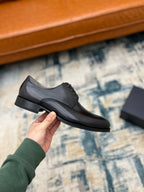 Prada lace-up dress shoe, dark leather, low heel and lace-up front detail.