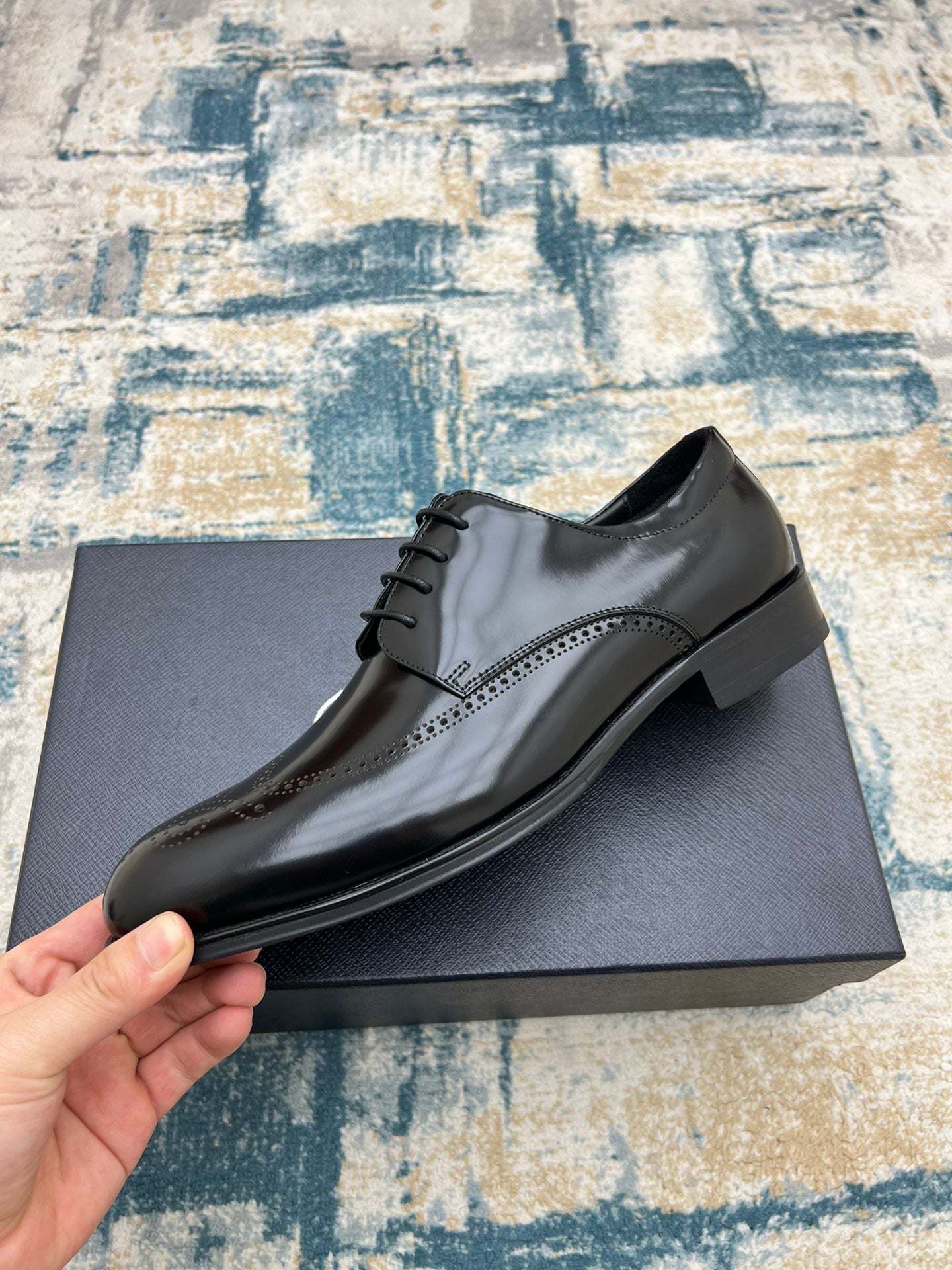 Black leather lace-up derby shoe with brogue-style perforations