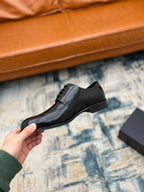 Black leather lace-up derby shoe with sleek upper and low sole