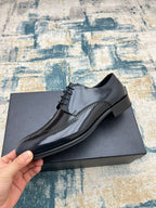 Prada dark leather lace-up shoe with perforated wingtip panel and black laces