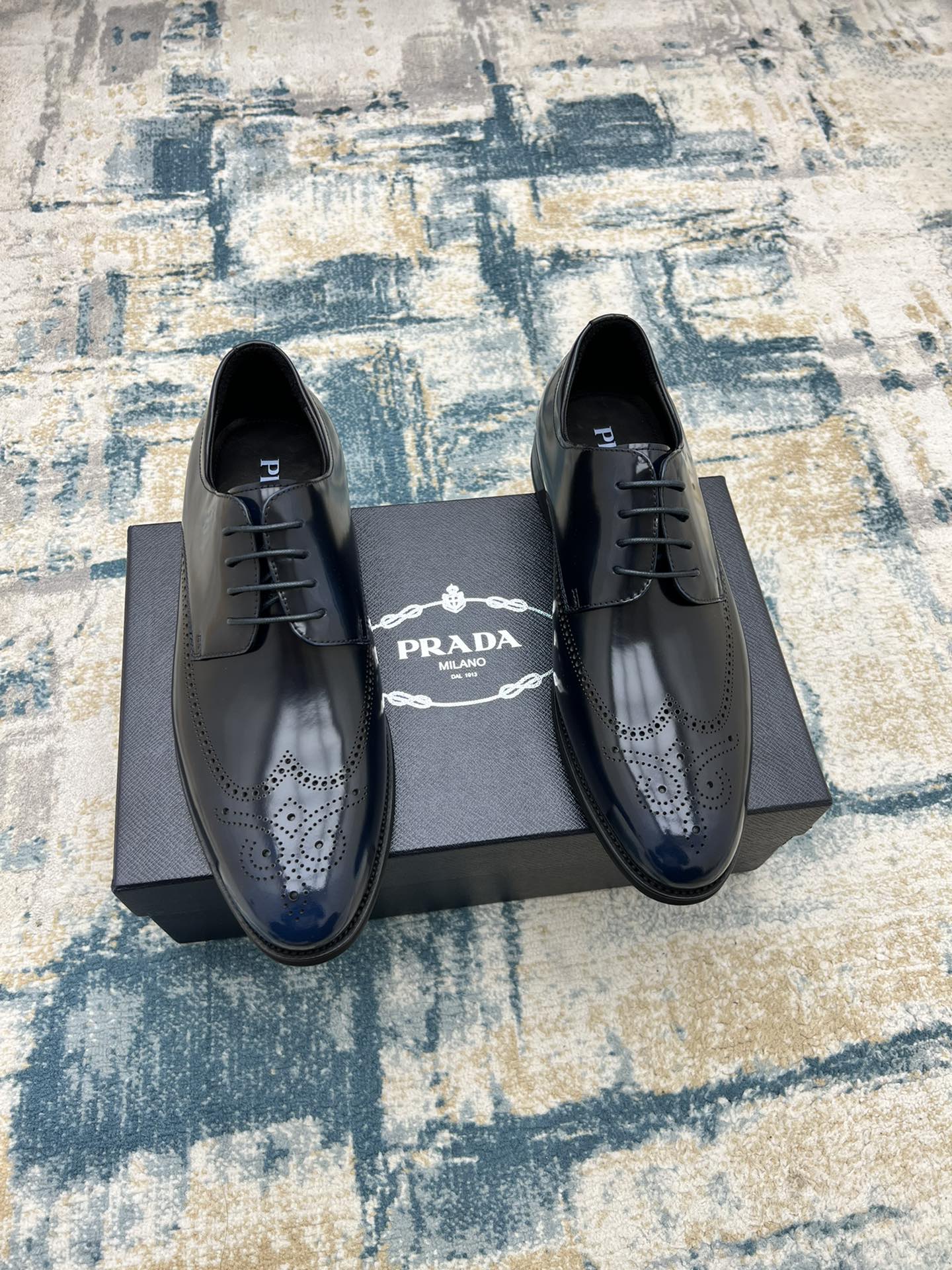 Prada lace-up leather shoes set in dark leather with perforated brogue detailing