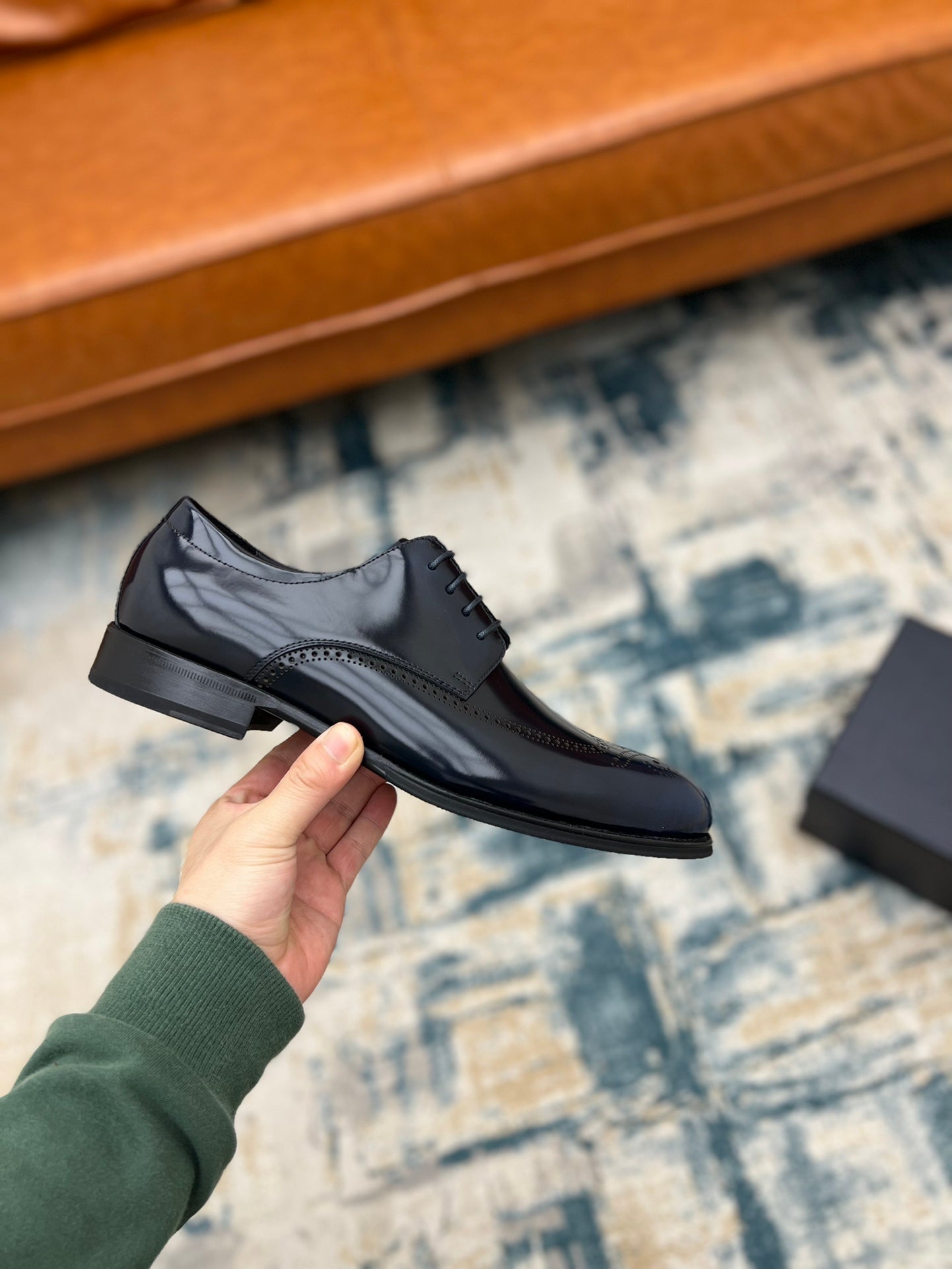 Prada lace-up leather derby shoe in dark leather with perforated panels and laces