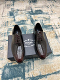 Prada unisex leather lace-up derby shoes, dark finish, perforated toe, with box