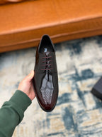 Prada unisex leather lace-up shoe on hand, front view with lace-up closure
