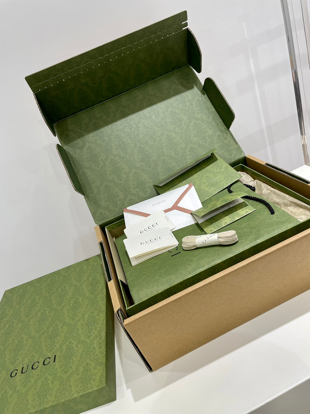 White Gucci unisex sneakers with blue-yellow star logos in gift set