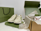 White Gucci unisex sneakers with lace-up front and blue-yellow star logos