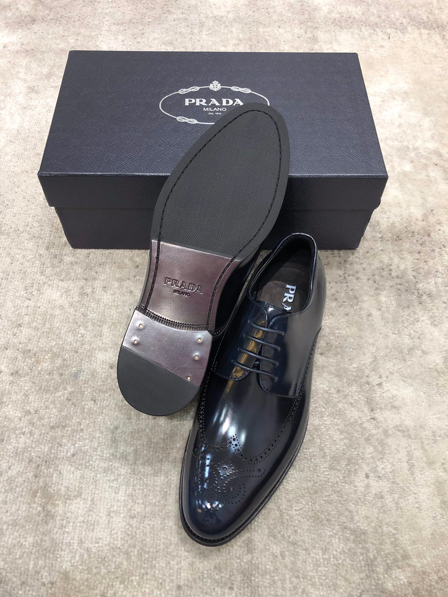 Prada unisex leather shoes with outsole visible, dark navy lace-up