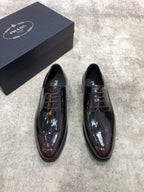 Prada lace-up dress shoes in dark brown patent leather, rounded toe, two shoes front